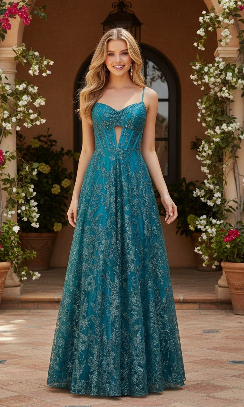 A woman stands outdoors among potted plants and flowers wearing the Blondie Nites 5949BN long prom dress—a teal, floor-length ball gown with a fitted corset bodice and lace pattern.